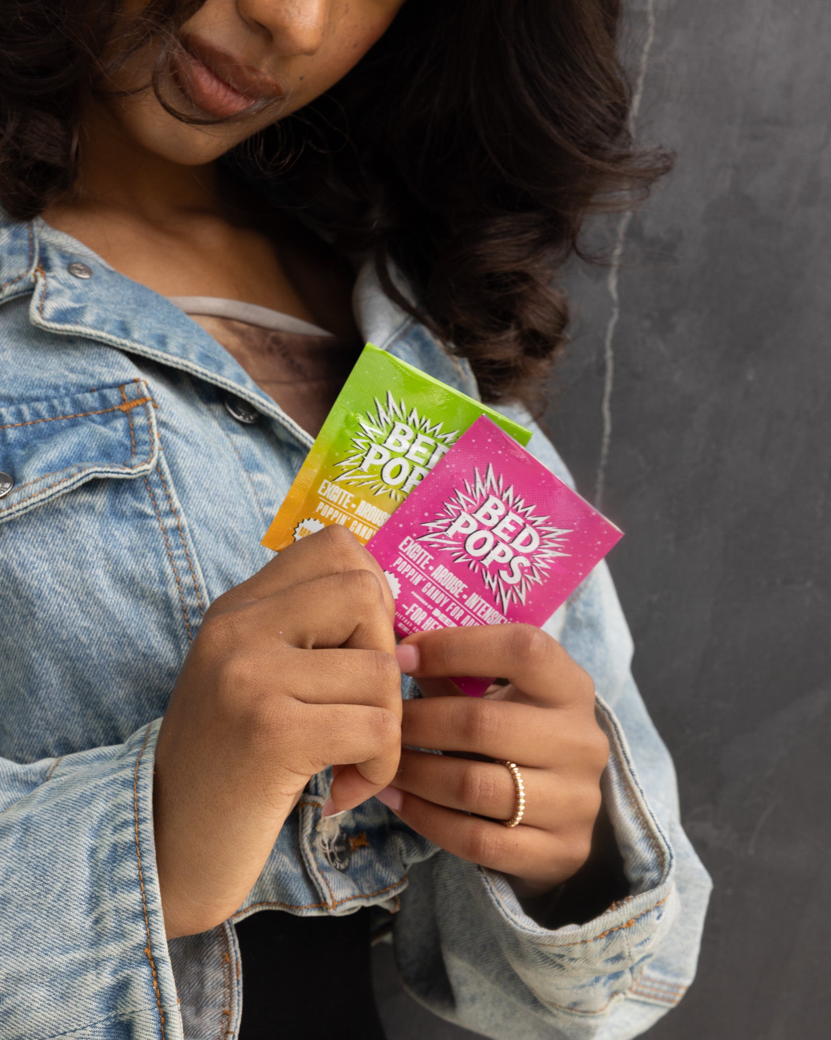 Person holding Bed Pops for Her mango and mint pouches